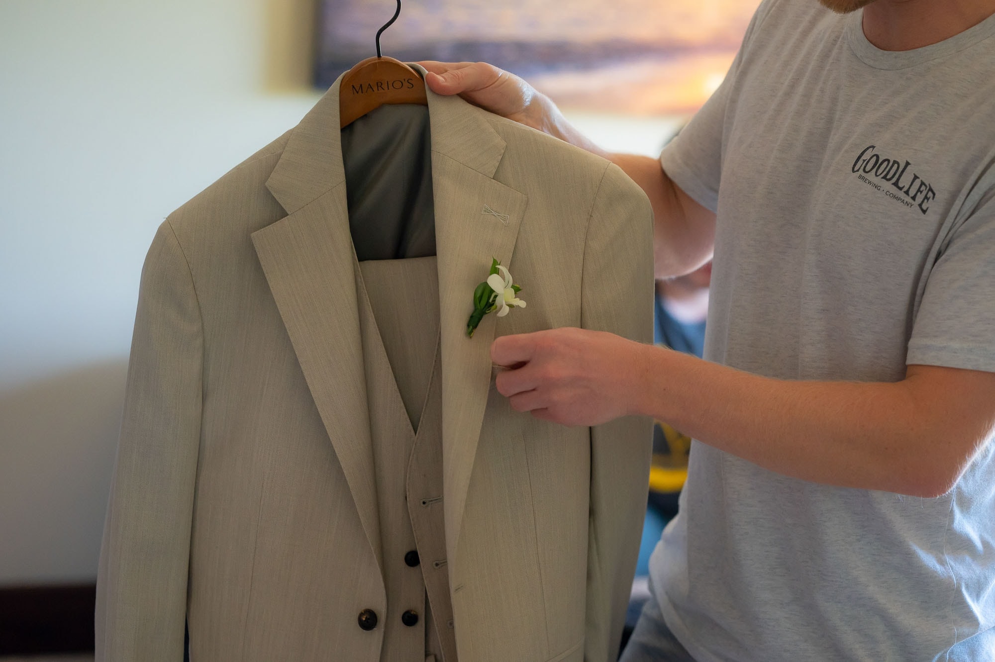 the groom prepping his suit