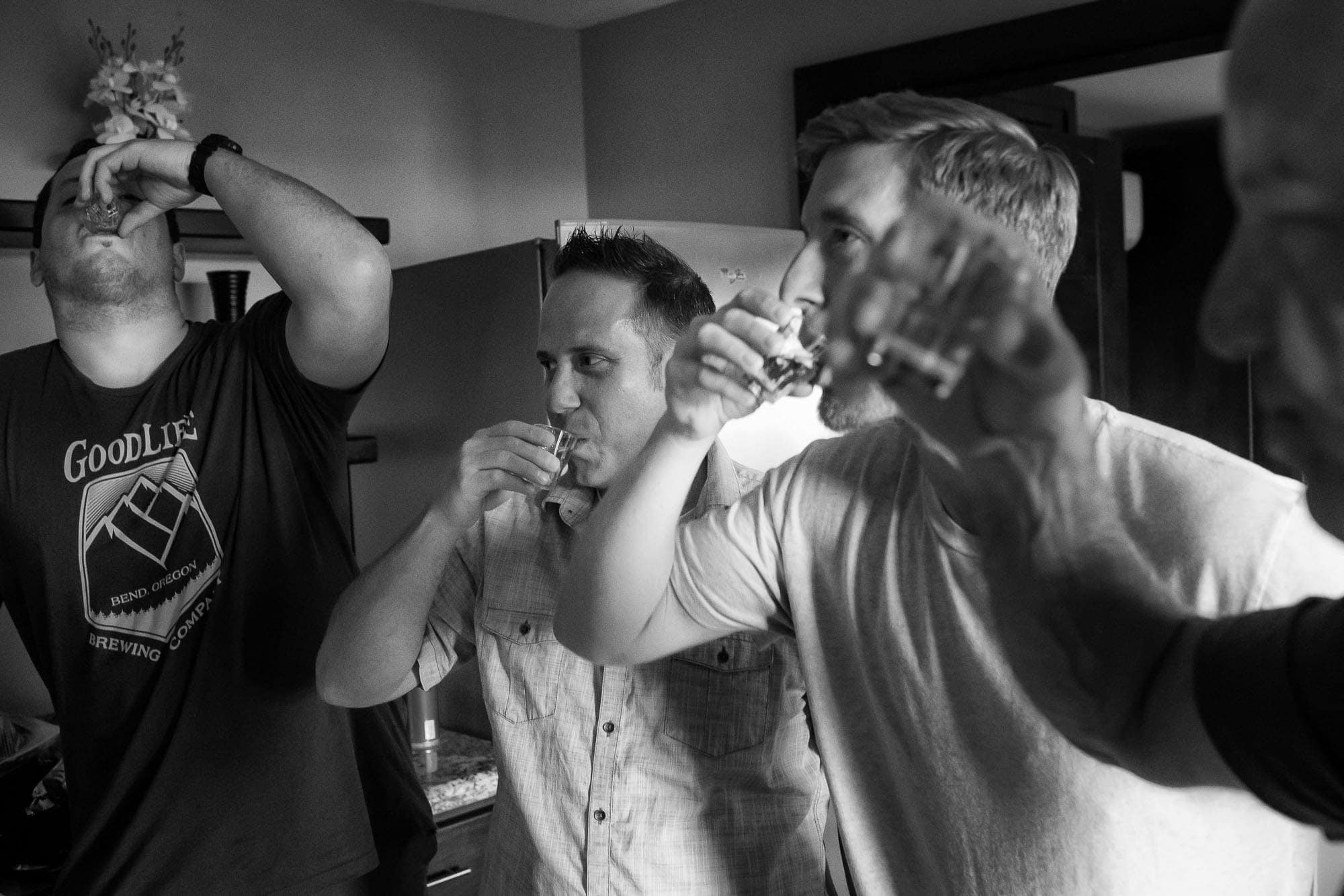 the groom and his buddies taking a shot