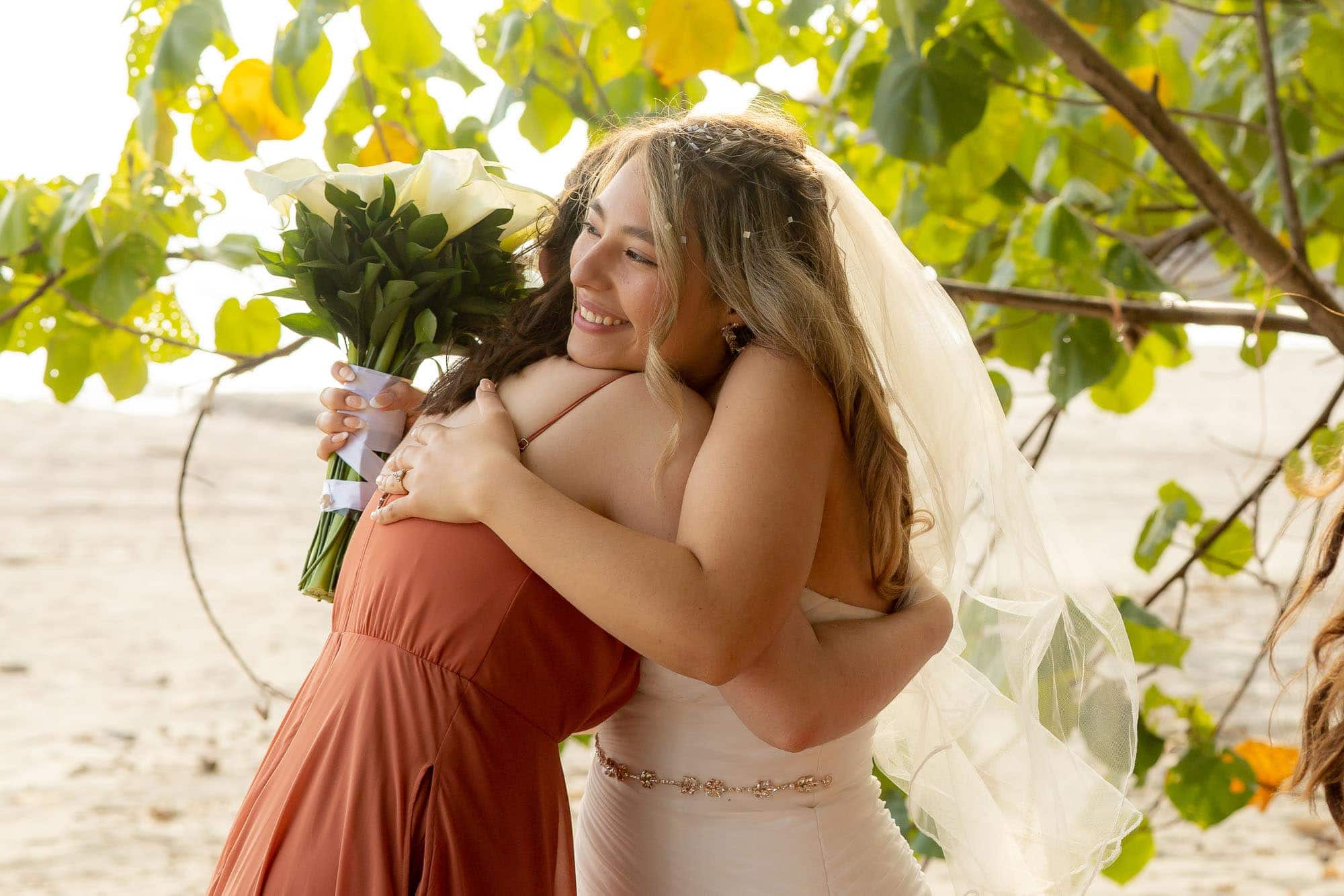 Bride embracing a bridesmaid