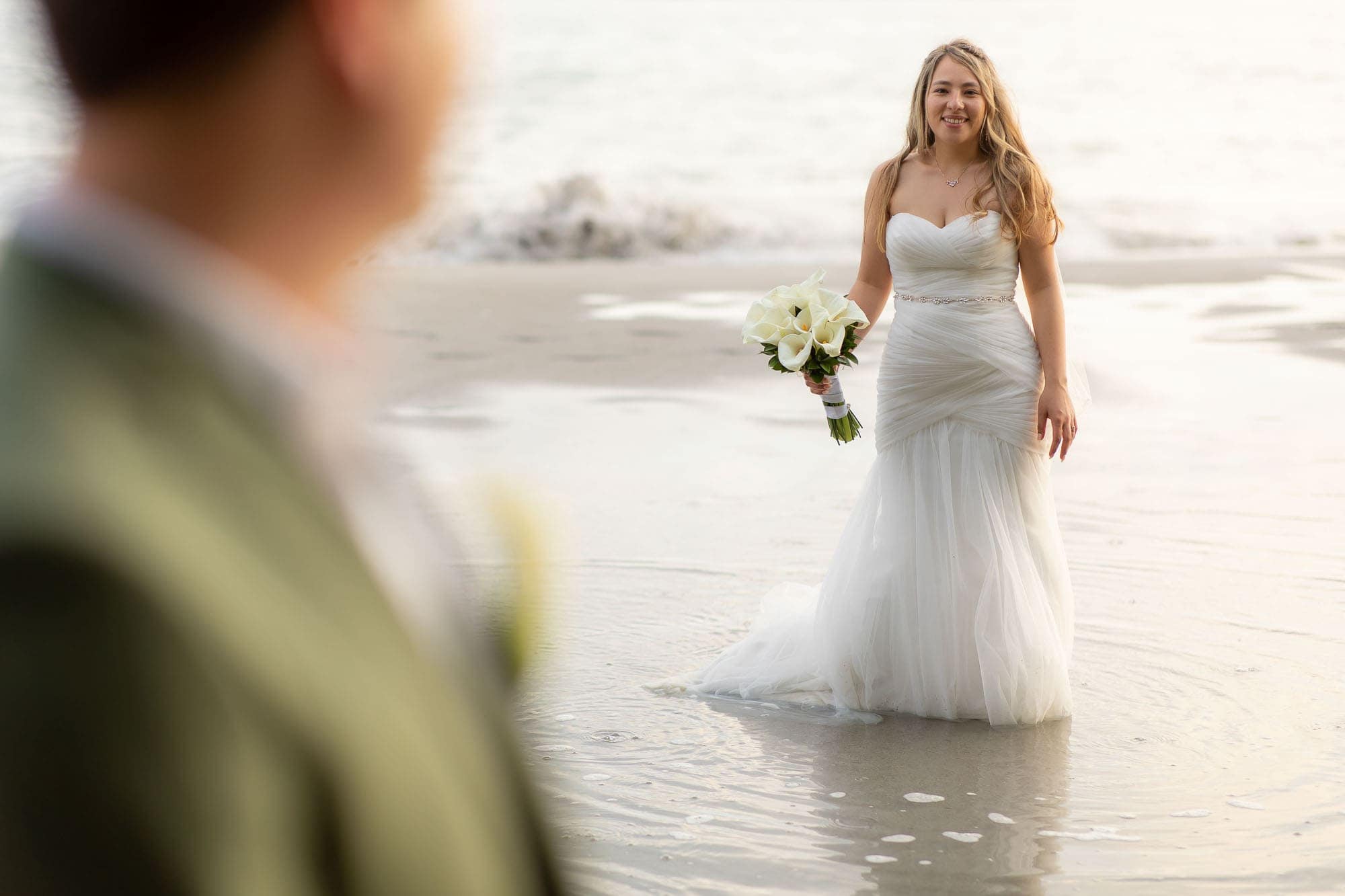 Bride on the beach with the groom