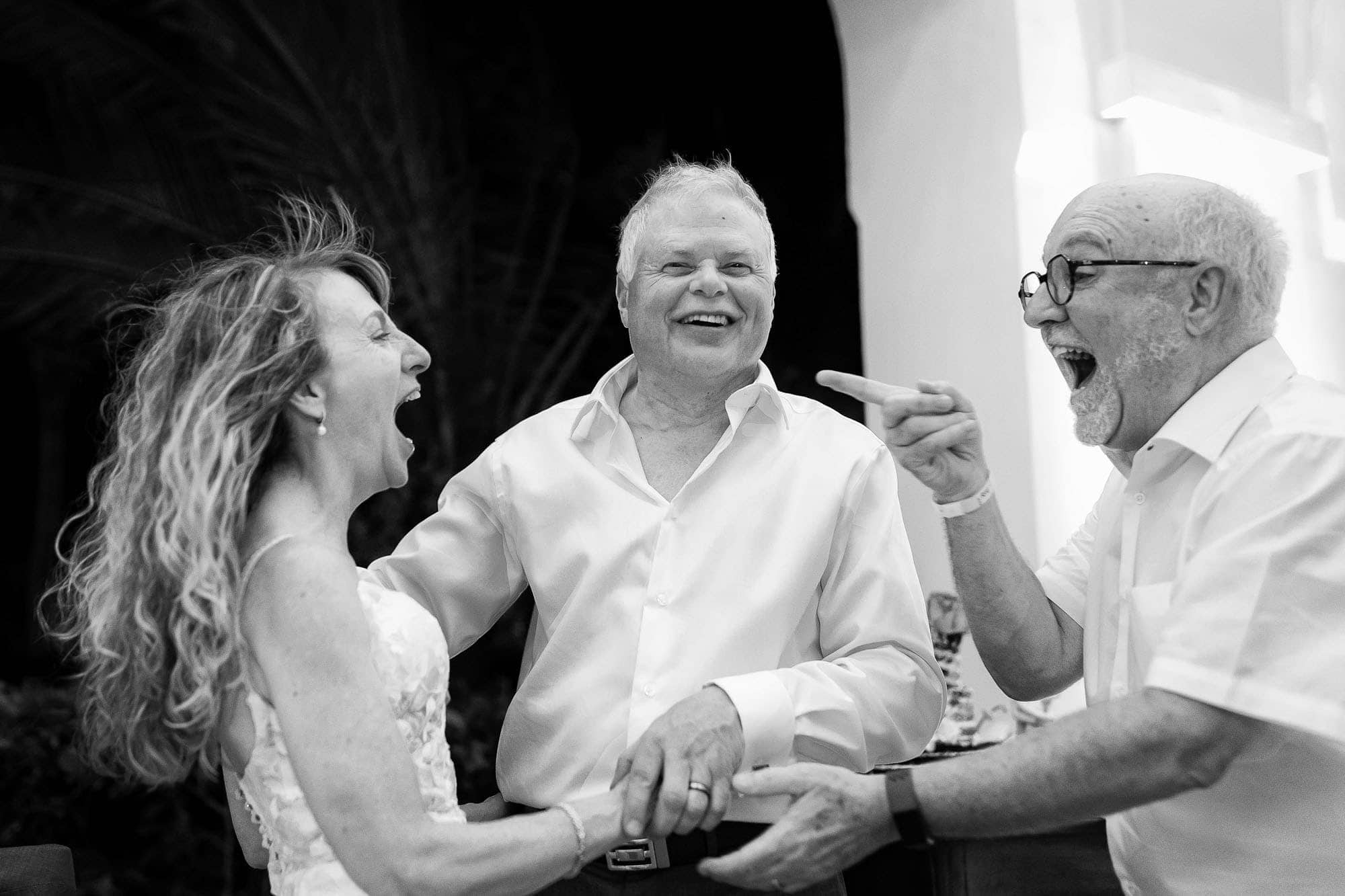 bride and groom and guest laughing