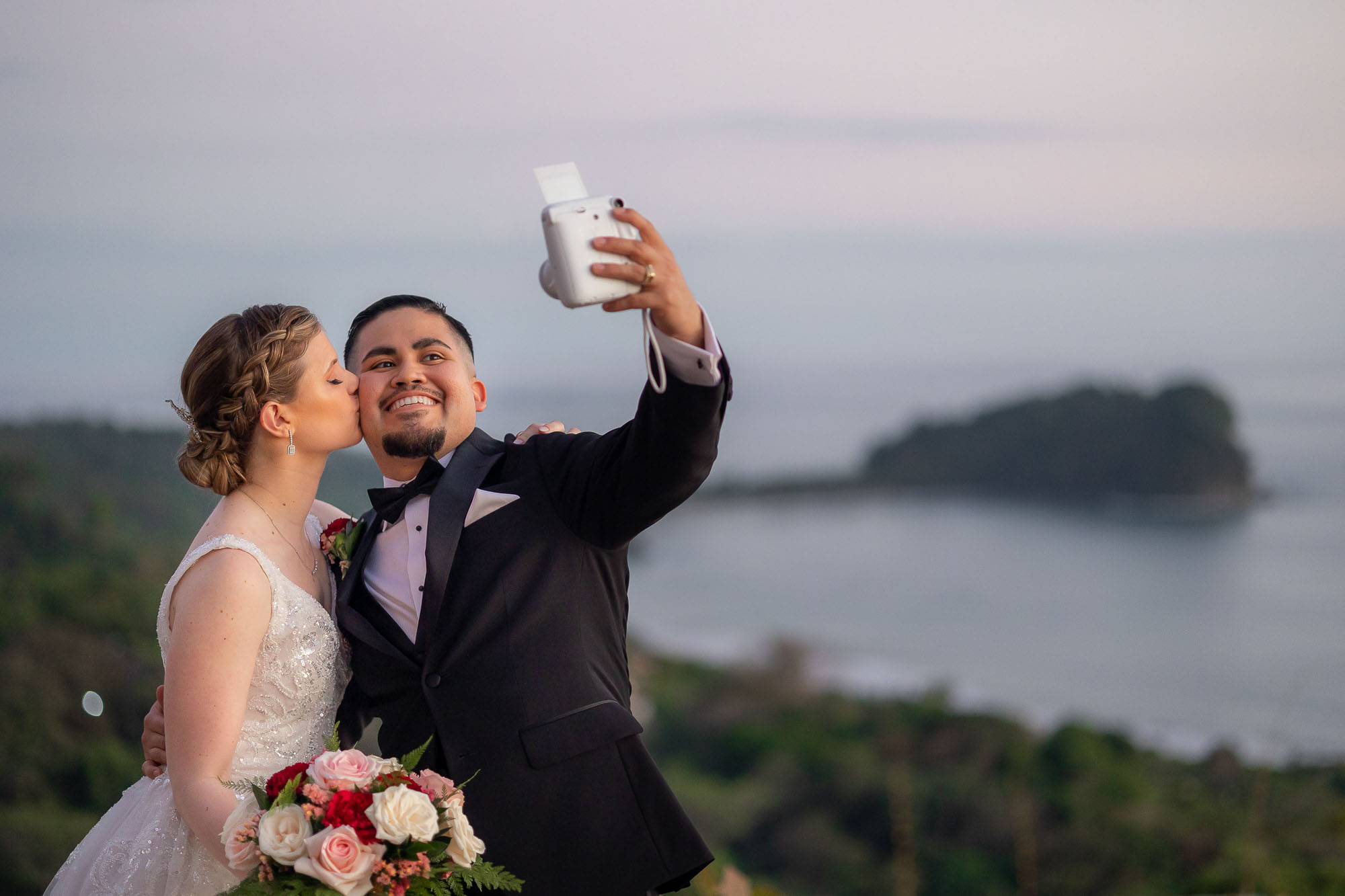 bride and groom taking a selfie with the view from La Mariposa Hotel