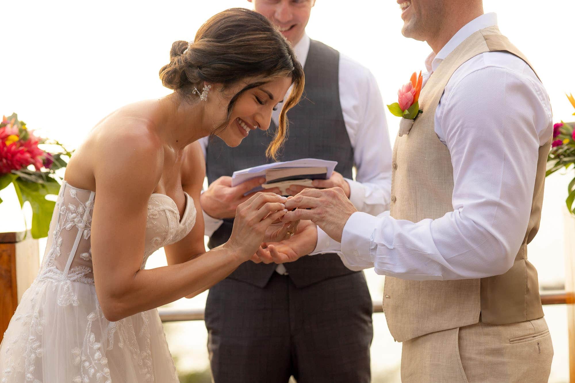 bride puts ring on the groom's finger