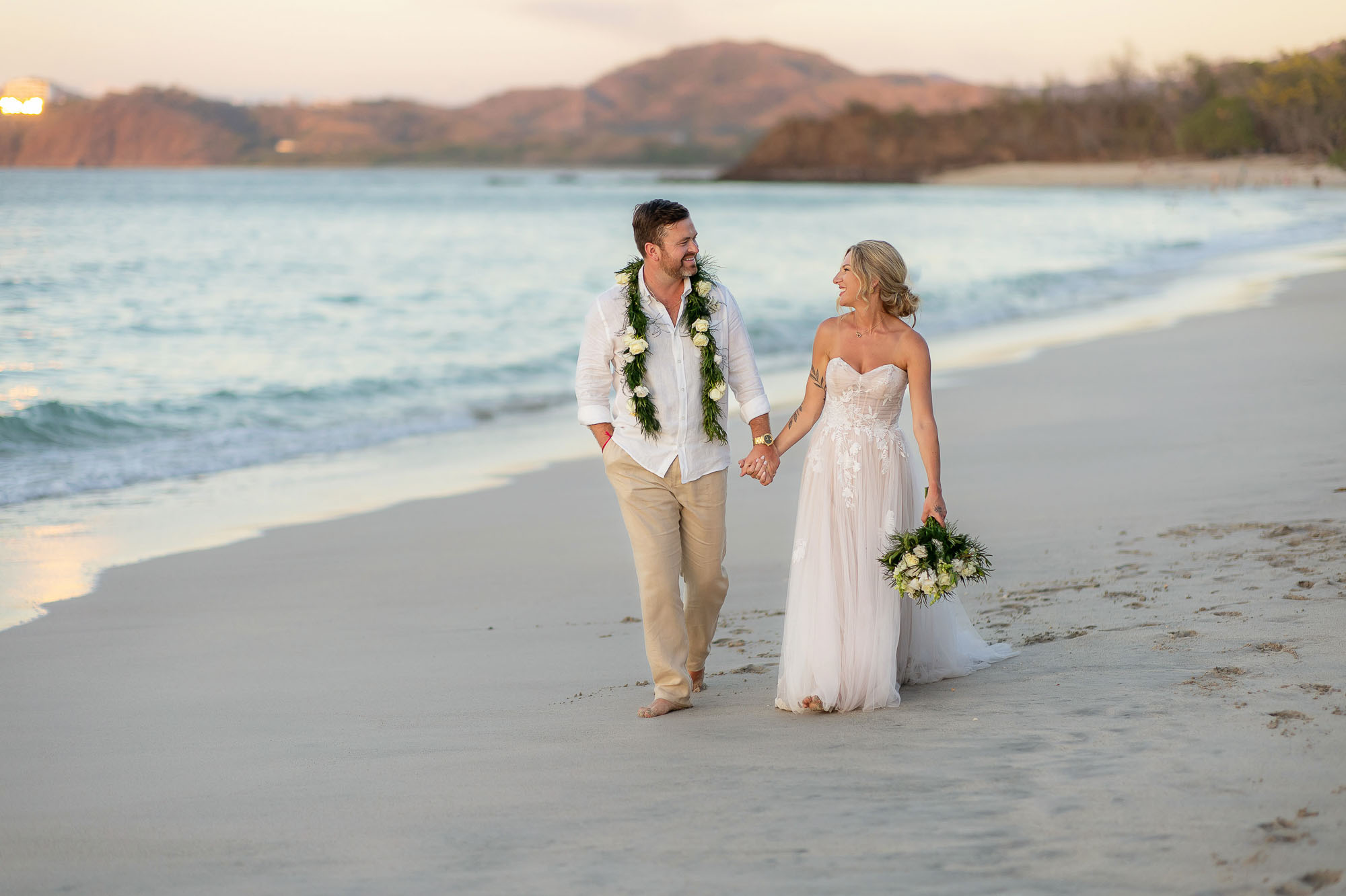 Wedding couple walking on the beach in Costa Rica